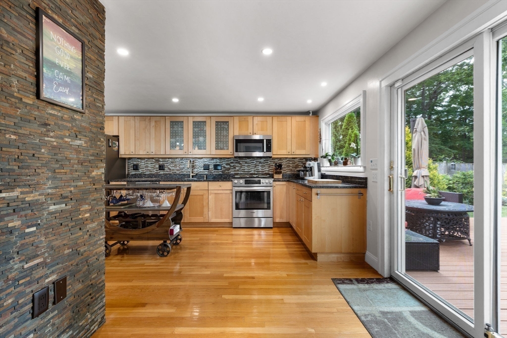 83 Payson Road Brookline, MA 02467 - Photo 7 of 34 a kitchen with stainless steel appliances granite countertop a stove a sink dishwasher and a microwave oven with cabinets