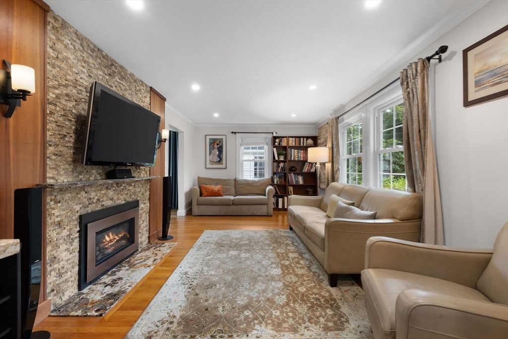 83 Payson Road Brookline, MA 02467 - Photo 9 of 34 a living room with fireplace furniture and a flat screen tv