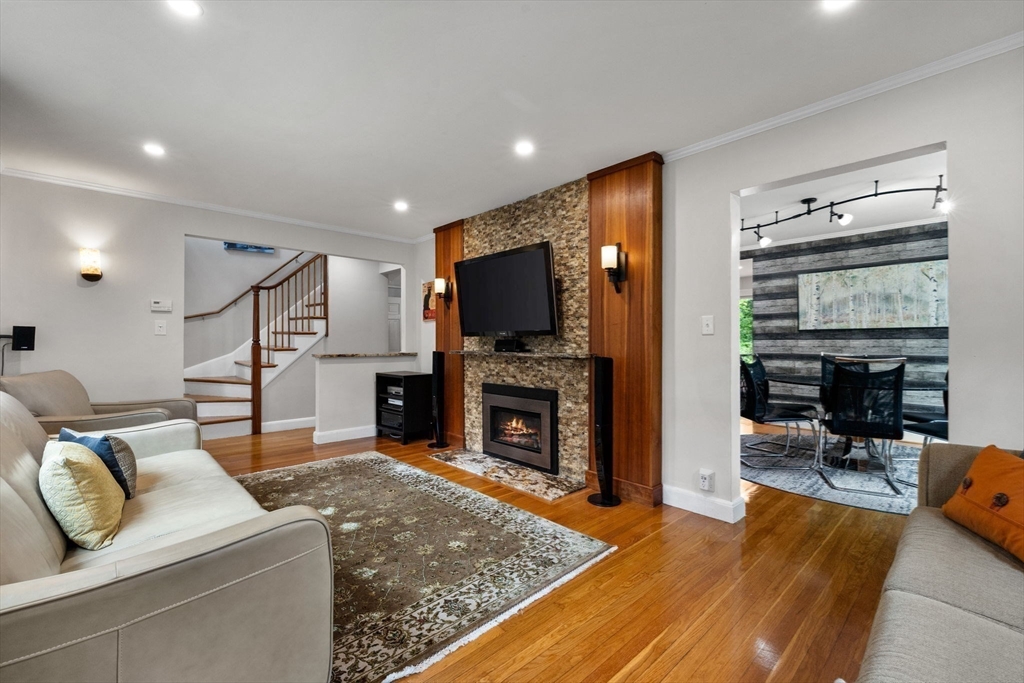 83 Payson Road Brookline, MA 02467 - Photo 10 of 34 a living room with fireplace furniture and a flat screen tv