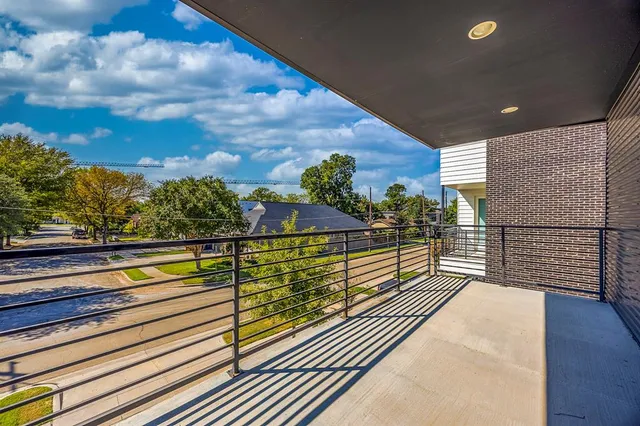 a view of a balcony with wooden floor and a potted plant
