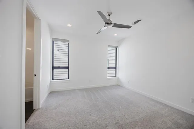 an empty room with windows and closet