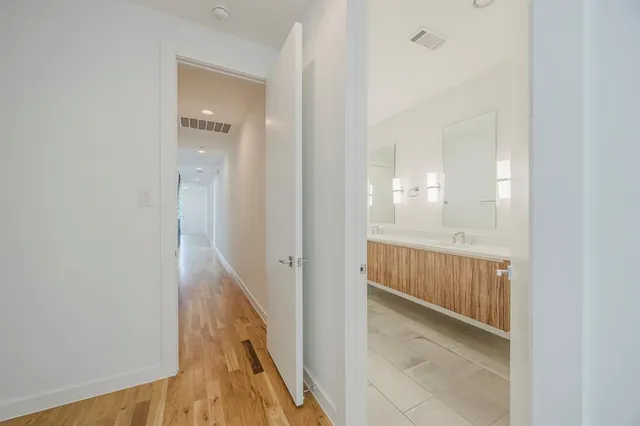 a view of a hallway with wooden floor