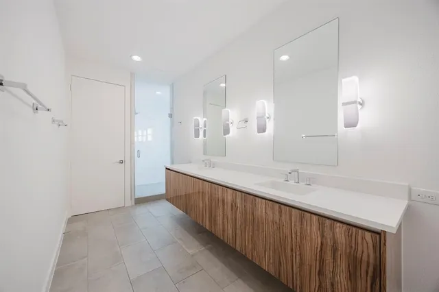 a bathroom with a double vanity sink and a mirror
