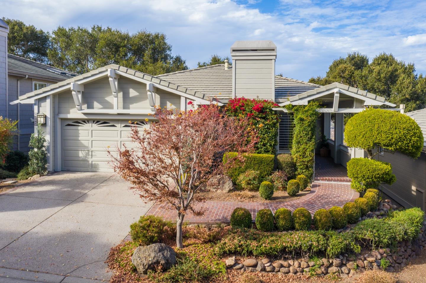 a view of a house with a yard and potted plants
