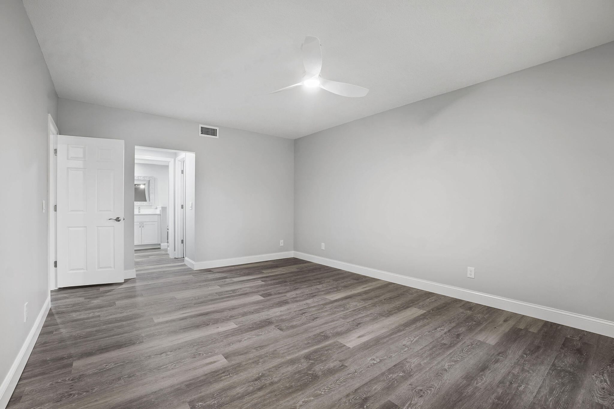250 Southeast Four Winds Drive, Unit 204 Stuart, FL 34996 - Photo 11 of 32 a view of an empty room and wooden floor