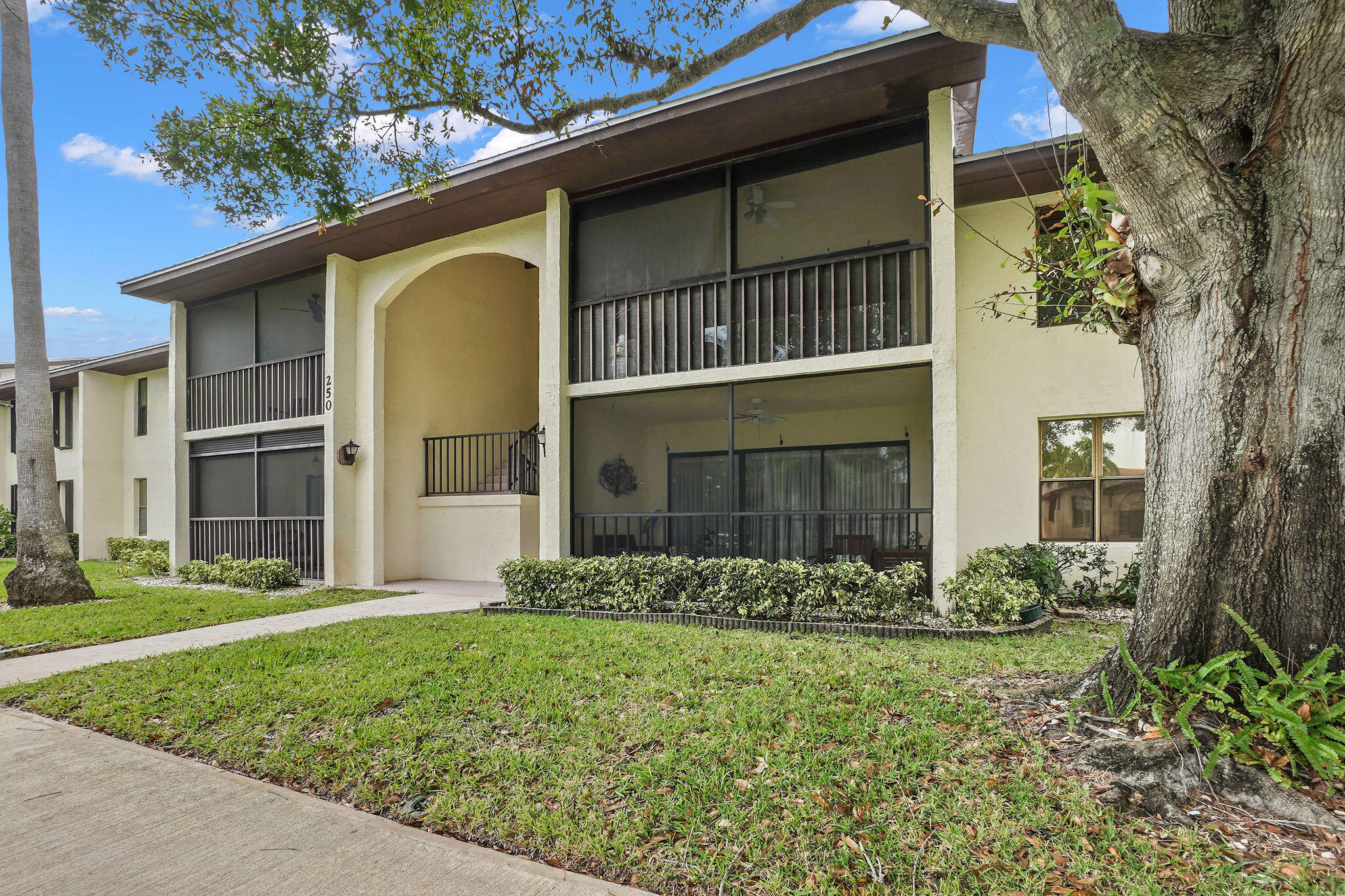 250 Southeast Four Winds Drive, Unit 204 Stuart, FL 34996 - Photo 23 of 32 a front view of a house with garden