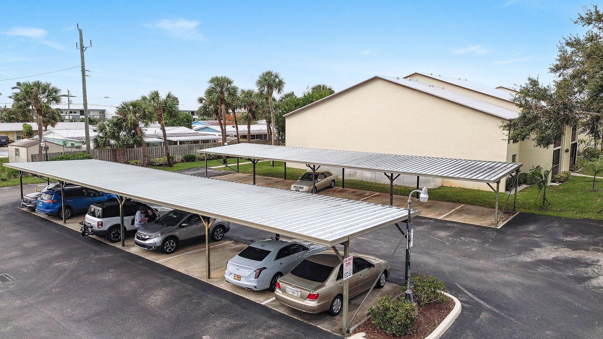 250 Southeast Four Winds Drive, Unit 204 Stuart, FL 34996 - Photo 24 of 32 a view of a backyard with furniture and outdoor kitchen