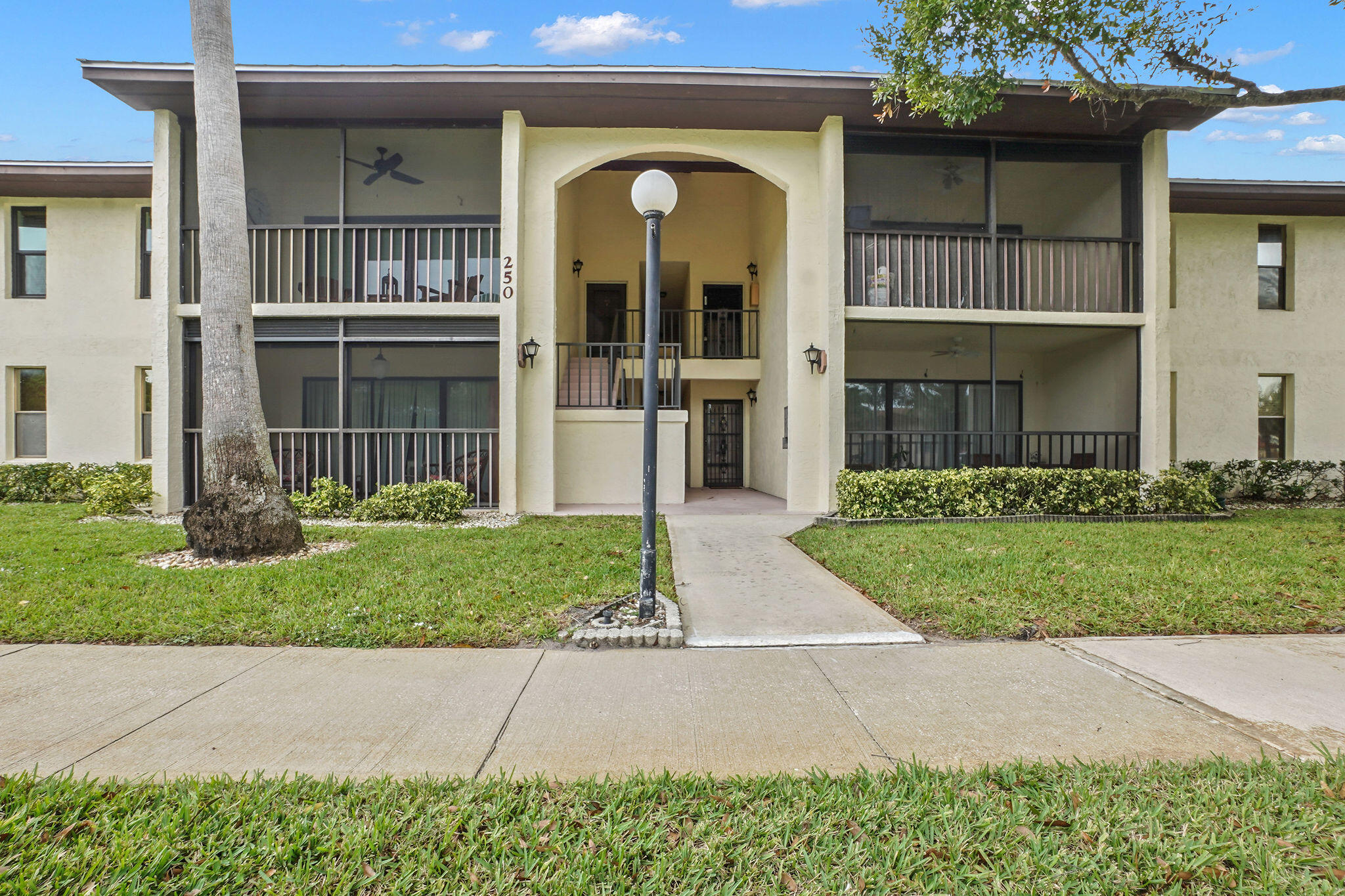 250 Southeast Four Winds Drive, Unit 204 Stuart, FL 34996 - Photo 25 of 32 a front view of a house with garden