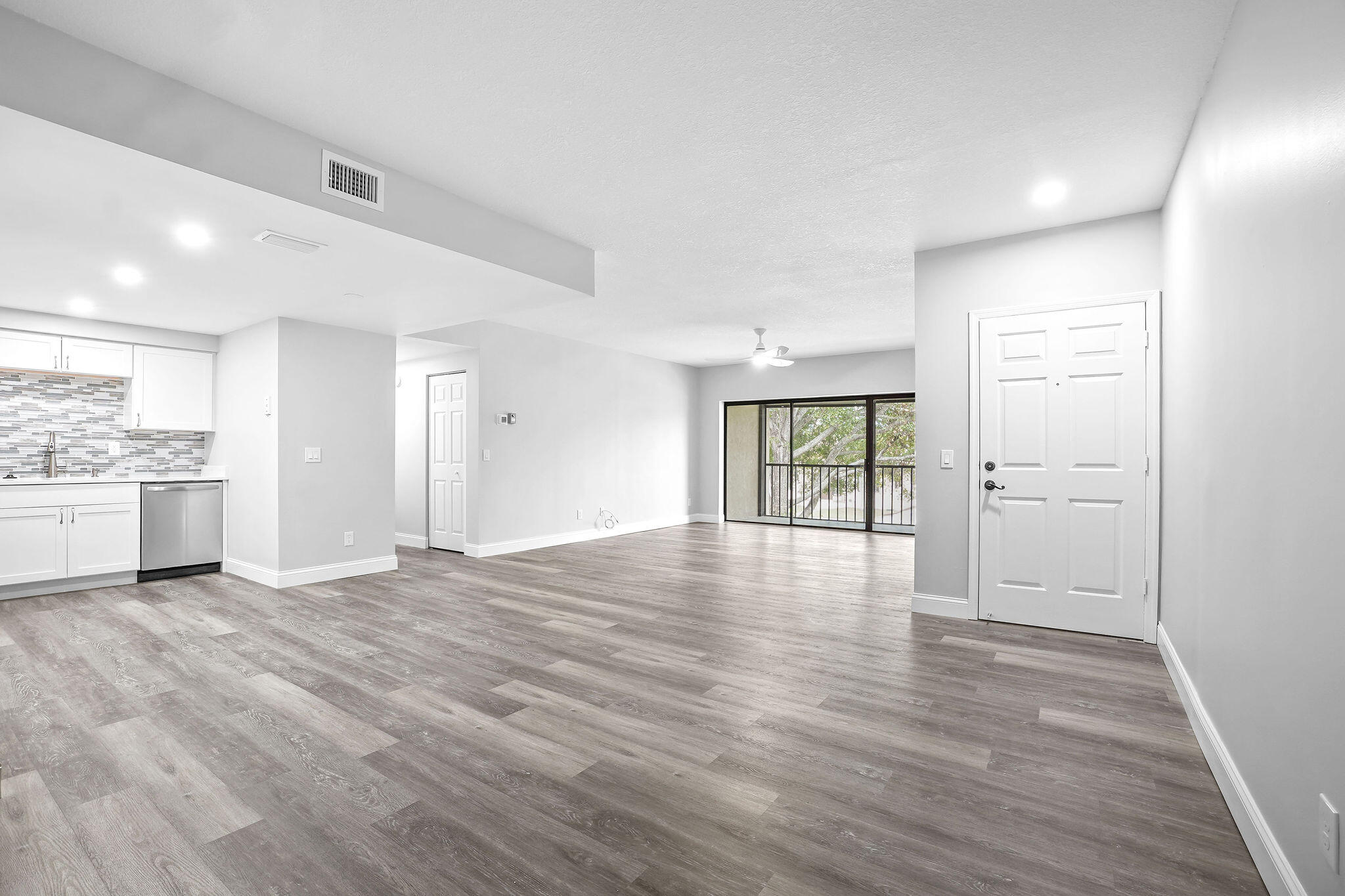 250 Southeast Four Winds Drive, Unit 204 Stuart, FL 34996 - Photo 5 of 32 a view of an empty room with wooden floor and a window