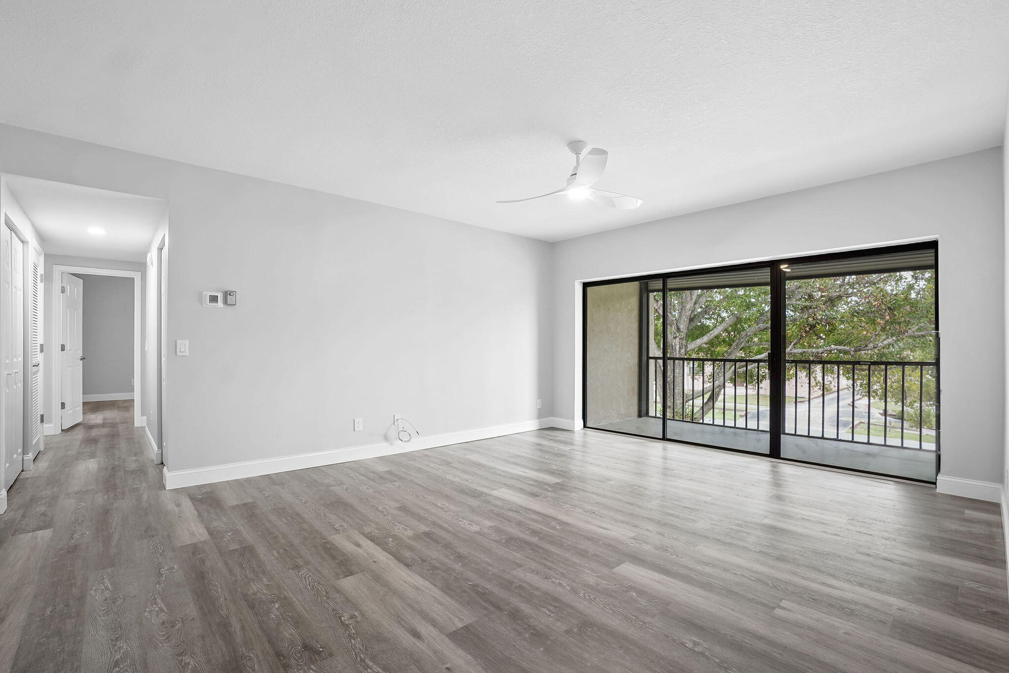 250 Southeast Four Winds Drive, Unit 204 Stuart, FL 34996 - Photo 7 of 32 wooden floor in an empty room with a window