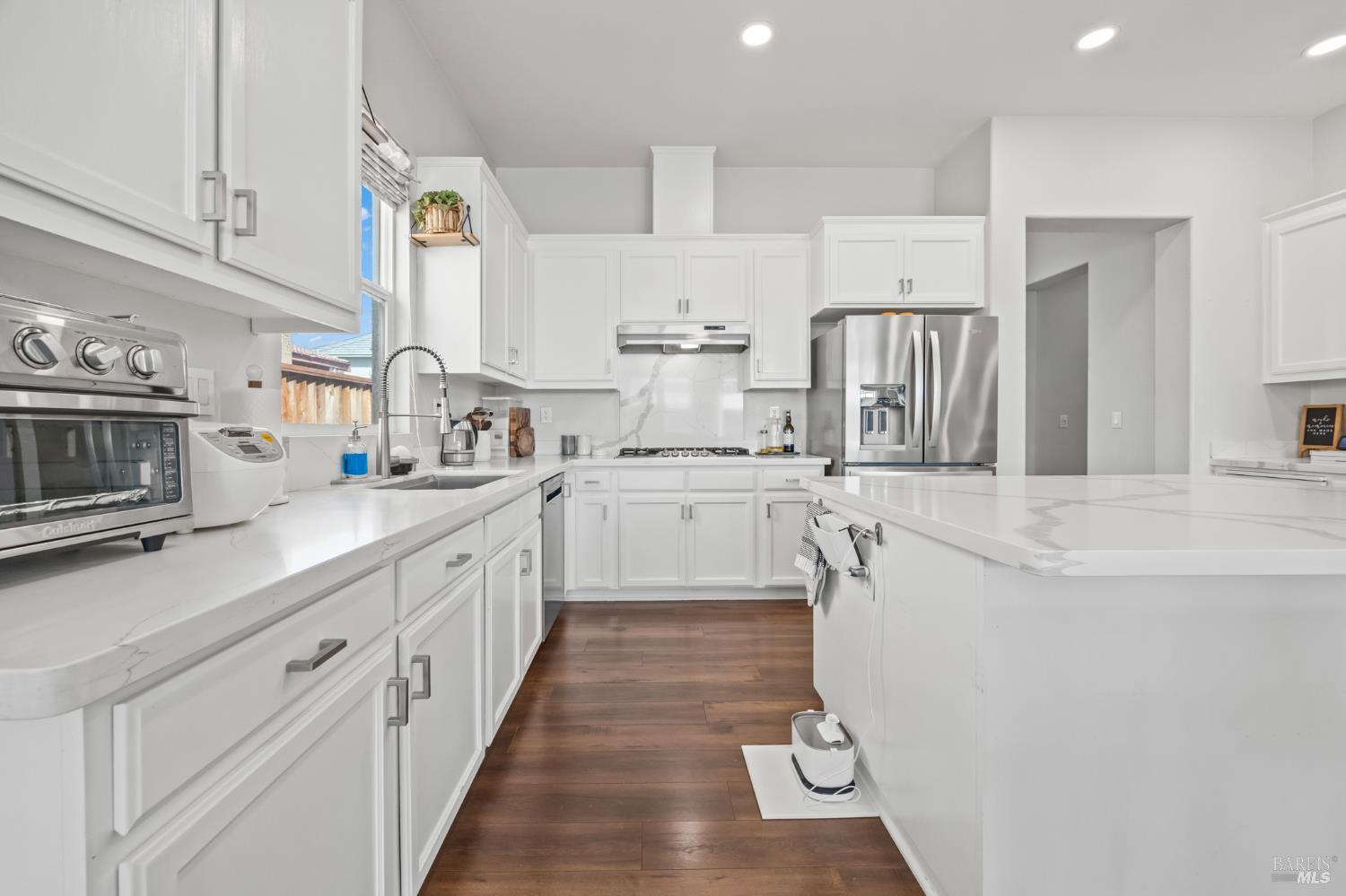5161 Freitas Way Fairfield, CA 94533 - Photo 15 of 51 a kitchen with kitchen island granite countertop lots of white cabinets a sink and appliances