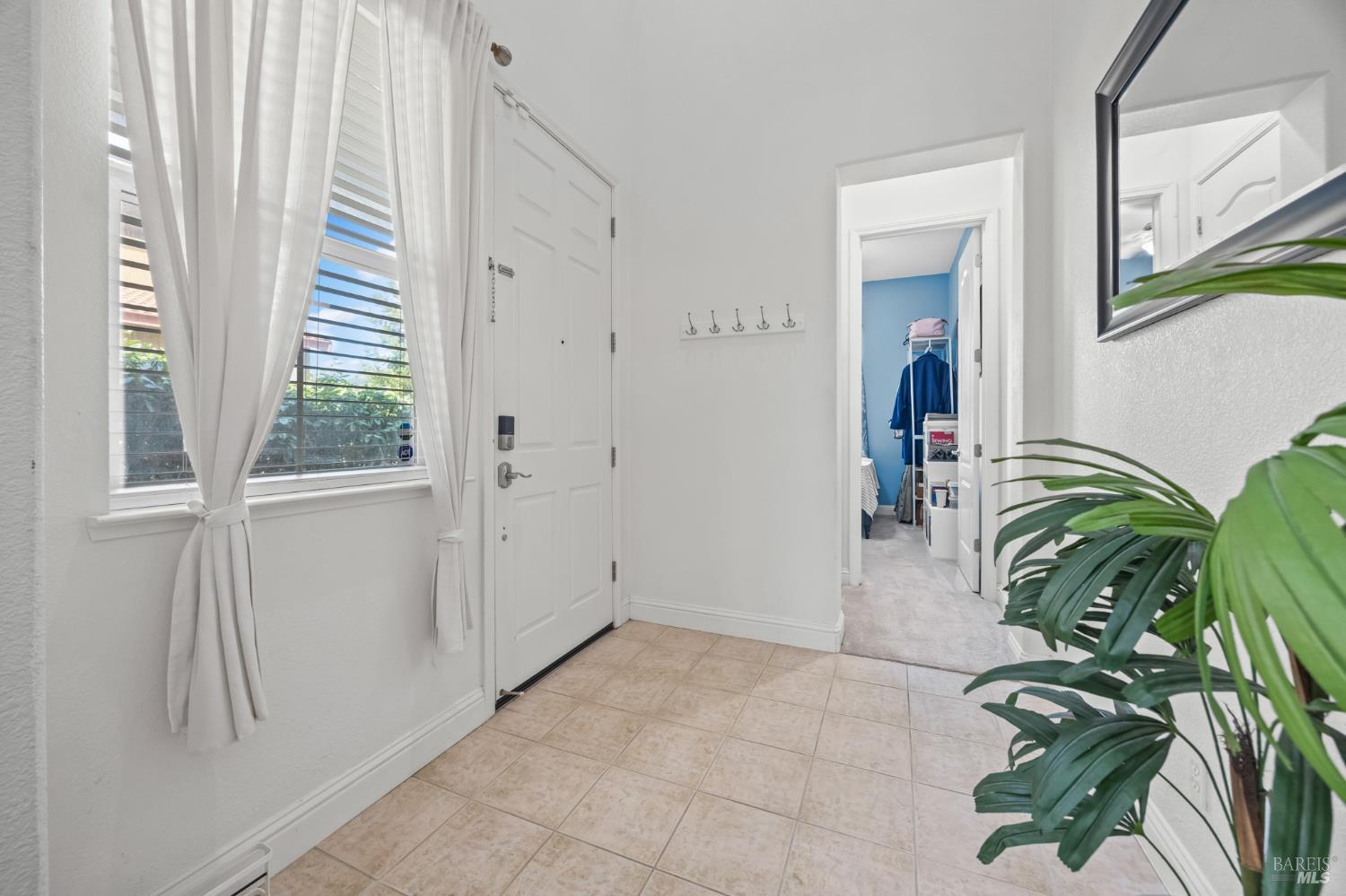 5161 Freitas Way Fairfield, CA 94533 - Photo 6 of 51 a hallway with painting and a potted plant