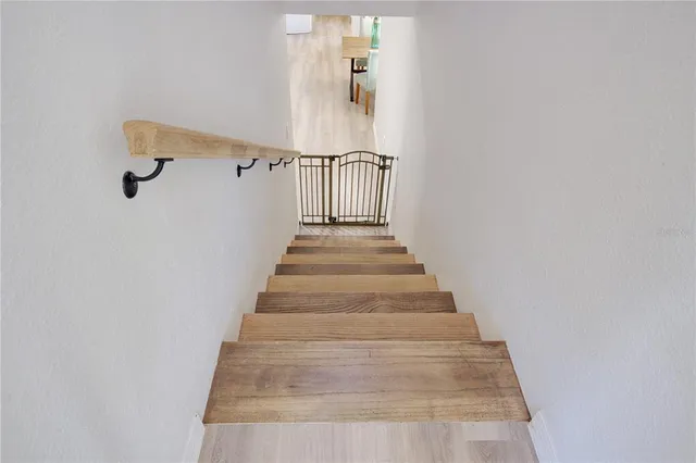 a spacious bedroom with a bed a chandelier and window