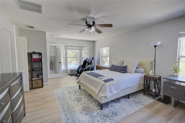 a view of a room that has a bed and a window