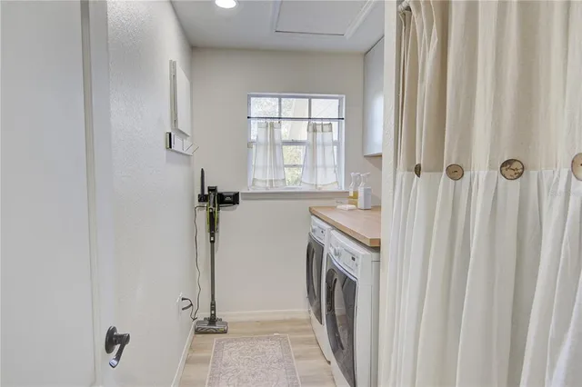 a view of a porch with chairs and potted plants