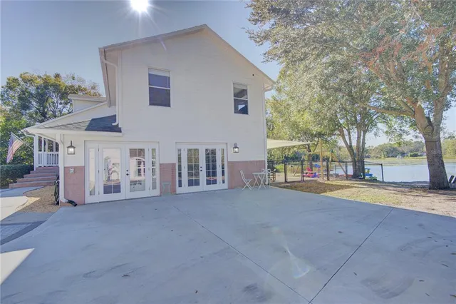 an aerial view of green landscape with trees houses and lake view