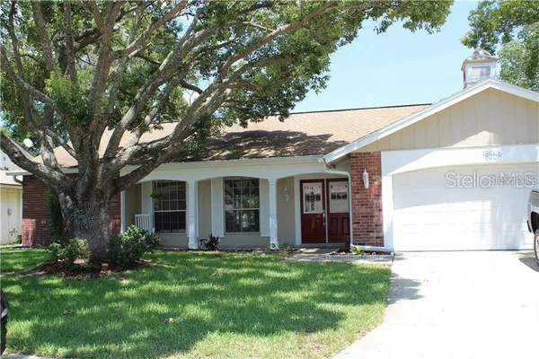 a view of a house with backyard porch and garden