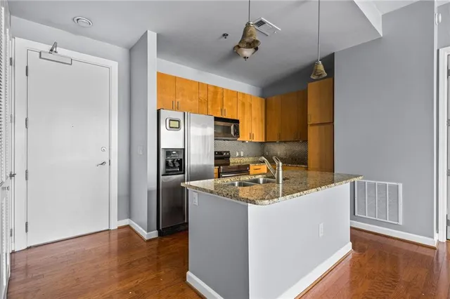 a kitchen with refrigerator cabinets and wooden floor