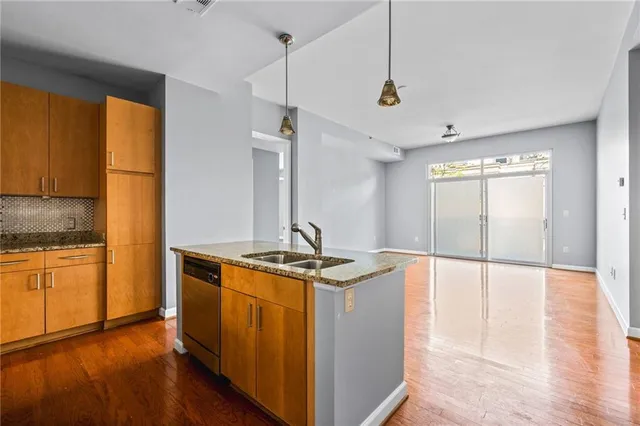 a kitchen with stainless steel appliances granite countertop a stove and a refrigerator