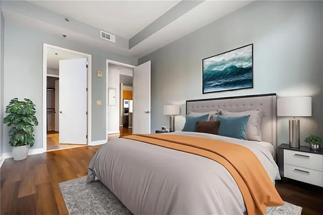 a bedroom with bed and a potted plant