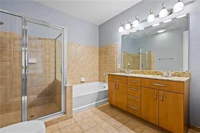 a bathroom with a tub sink shower and mirror