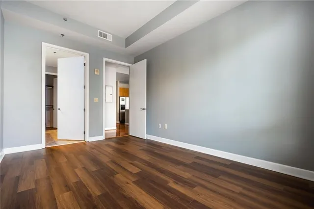 a view of an empty room with wooden floor