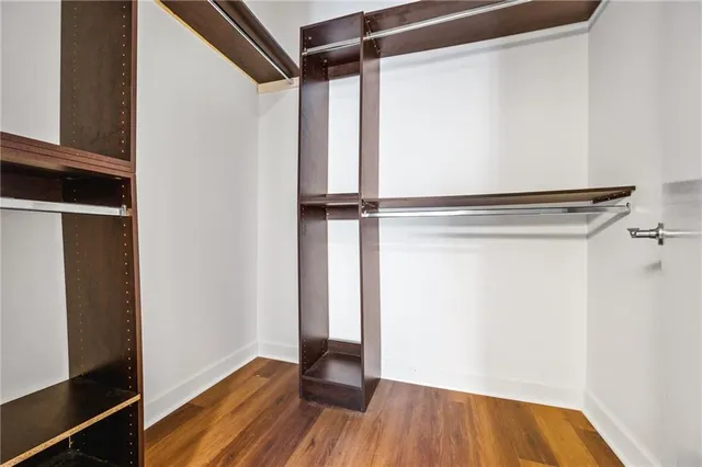 a view of walk in closet with empty racks
