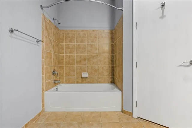 a bathroom with a bathtub and shower