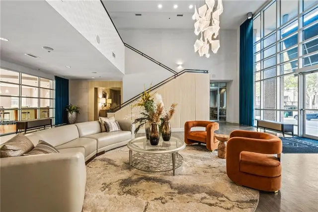 a living room with furniture and a chandelier