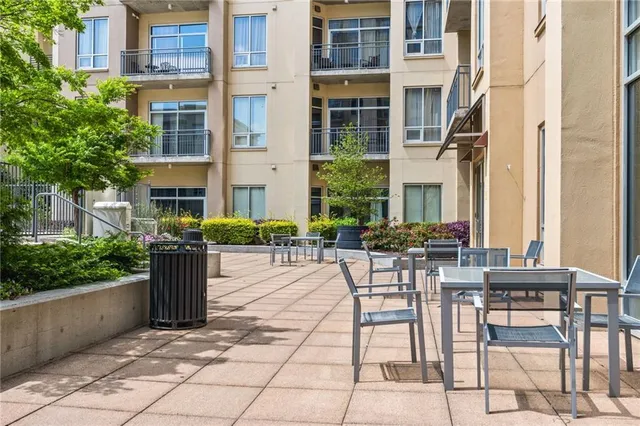 a view of a patio with a table and chairs and potted plants