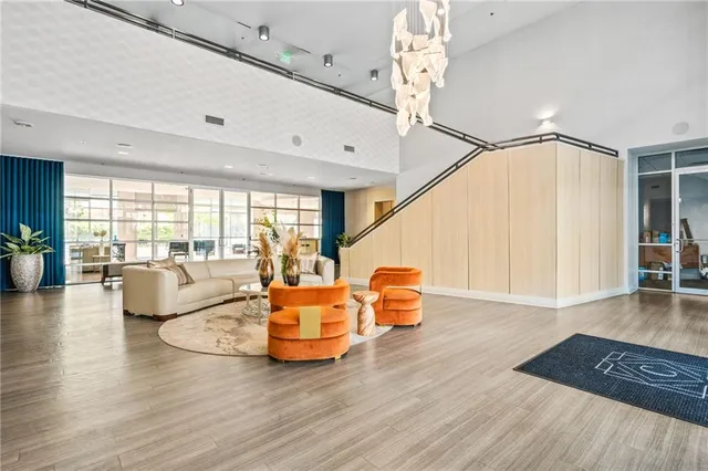 a living room with furniture rug and wooden floor
