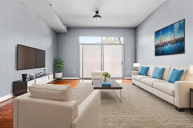 a living room with furniture and a flat screen tv