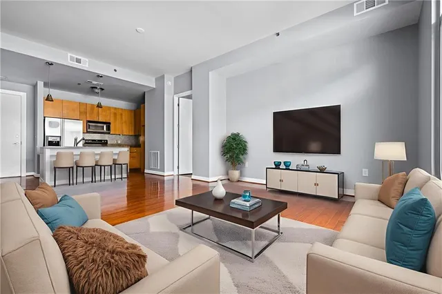 a living room with furniture and a flat screen tv