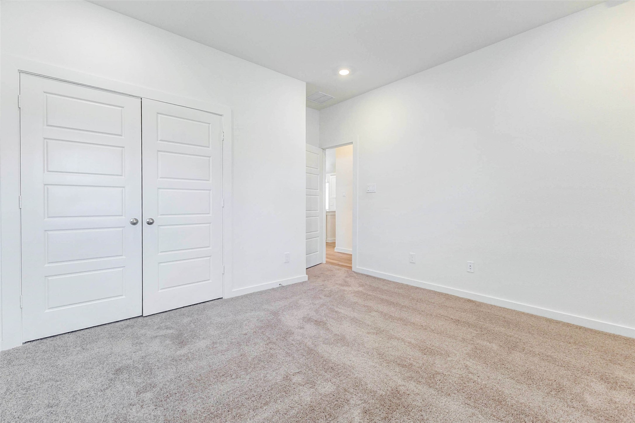 6463 Escondido Drive Rosharon, TX 77583 - Photo 17 of 30 Secondary bedroom view showcasing soft carpet, neutral paint, recessed lighting, and double closet doors. The simple, bright finish makes the room easy to personalize and provides a functional layout for a variety of furniture arrangements.