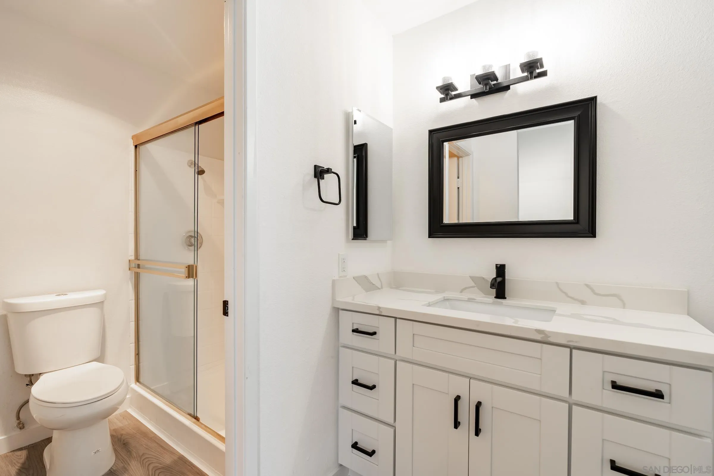 418 Kurdson Way Spring Valley, CA 91977 - Photo 20 of 25 a bathroom with a toilet sink and mirror