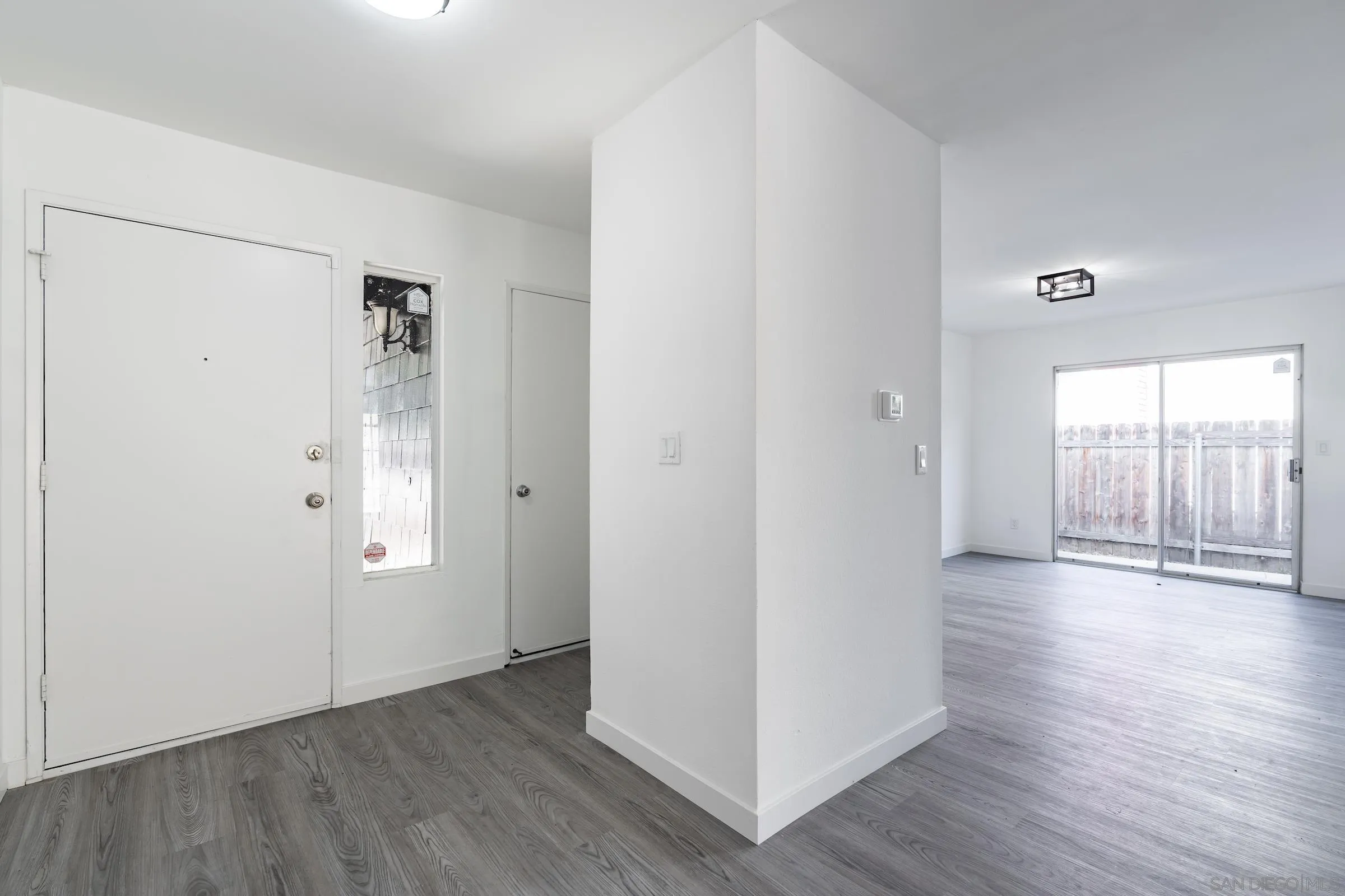 418 Kurdson Way Spring Valley, CA 91977 - Photo 3 of 25 an empty room with wooden floor and windows