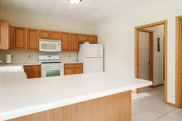 a kitchen with appliances cabinets and a counter top space