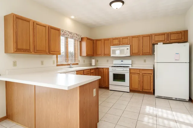 a kitchen with stainless steel appliances white cabinets and a sink