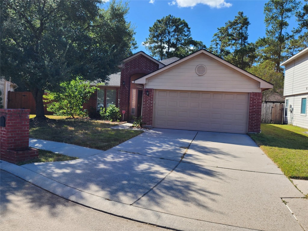 a front view of a house with a yard and a garage