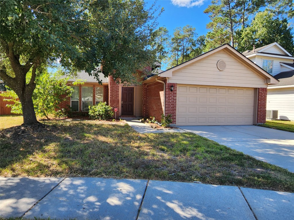 23107 Kimberly Glen Lane Spring, TX 77373 - Photo 2 of 8 a front view of house with yard and trees