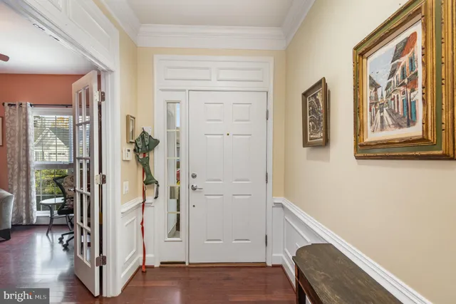 a view of a hallway with wooden floor and windows