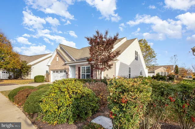 a view of a house with a big yard and fountain