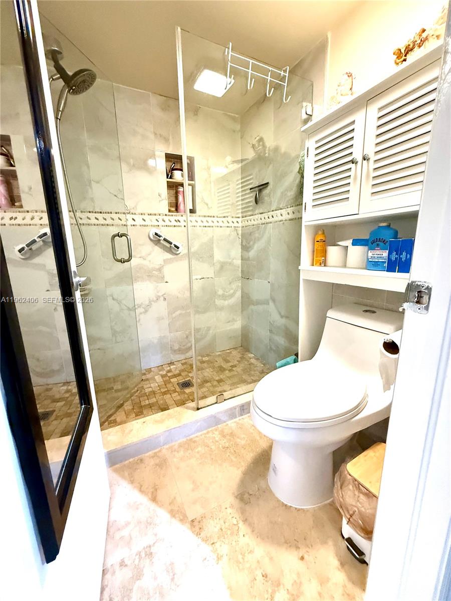 351 Club Circle, Unit 102 Boca Raton, FL 33487 - Photo 23 of 34 a bathroom with a toilet and a shower