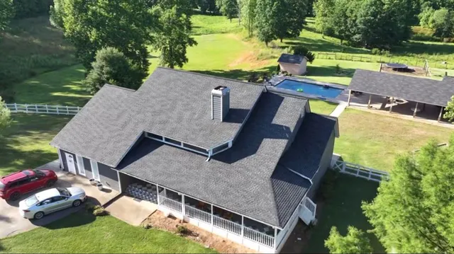 a view of a house with backyard and porch