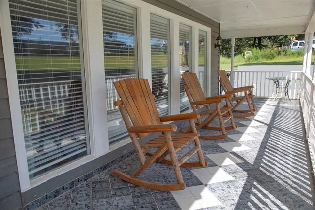 a view of kitchen with stainless steel appliances wooden floor and cabinet