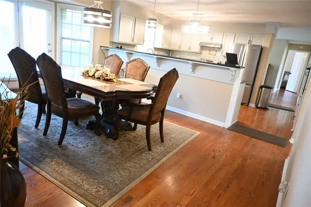 a view of a house with a swimming pool and sitting area