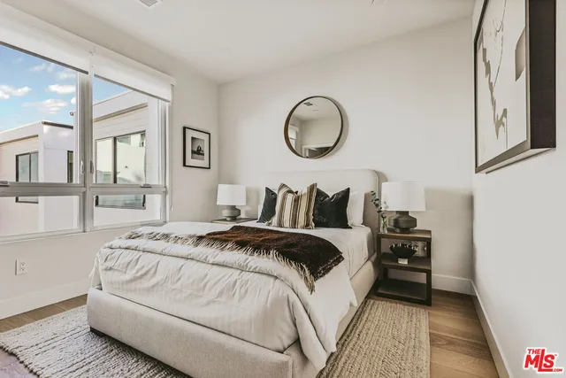 a bedroom with bed and a window