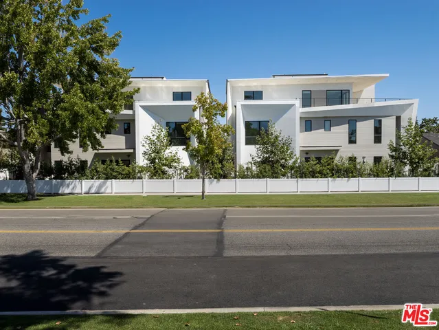 a view of a brick house with a yard