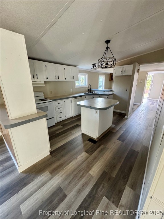 110 Flynn McPherson Road Cameron, NC 28326 - Photo 4 of 19 a kitchen with kitchen island a stove a sink and a refrigerator