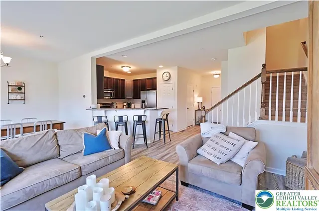 a living room with furniture and kitchen view